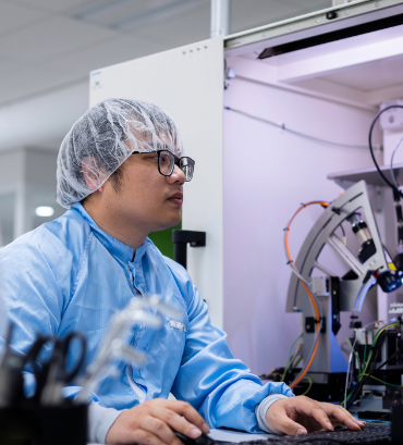Employee in cleanroom Employee in cleanroom